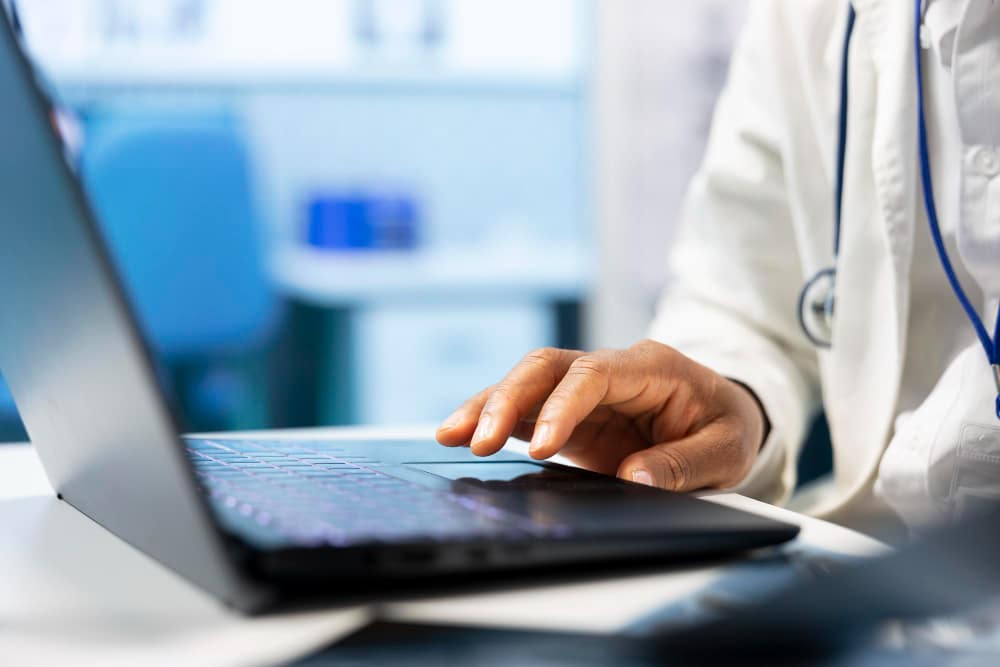 Doctor using laptop in office