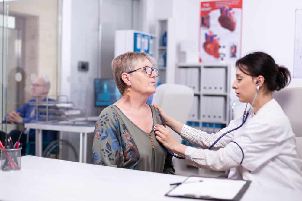 Doctor examining patient's heart rhythm