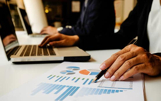Business professionals looking at financial graphs