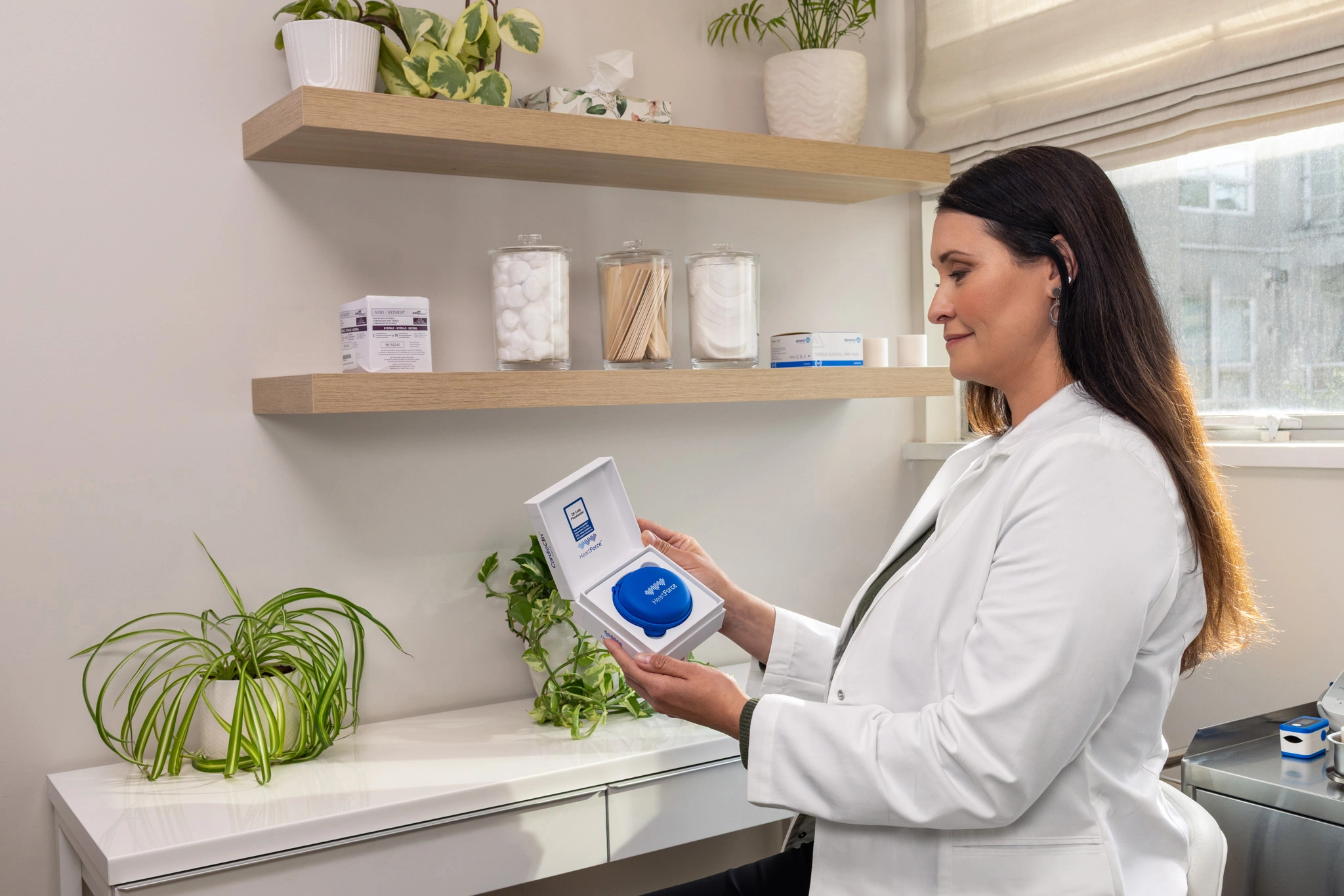 Healthcare professional unboxing CardioClin with the HeartForce pouch