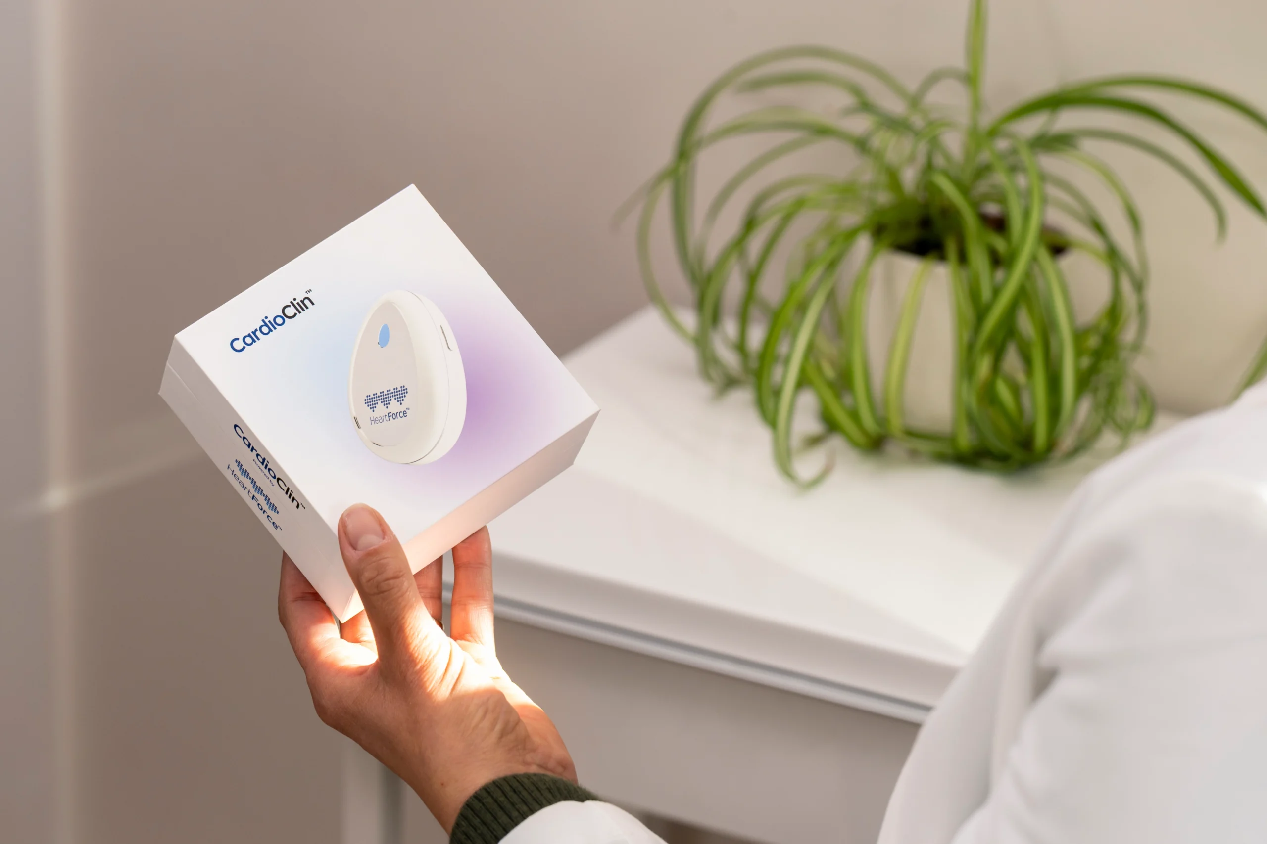 Hand holding the CardioClin product box