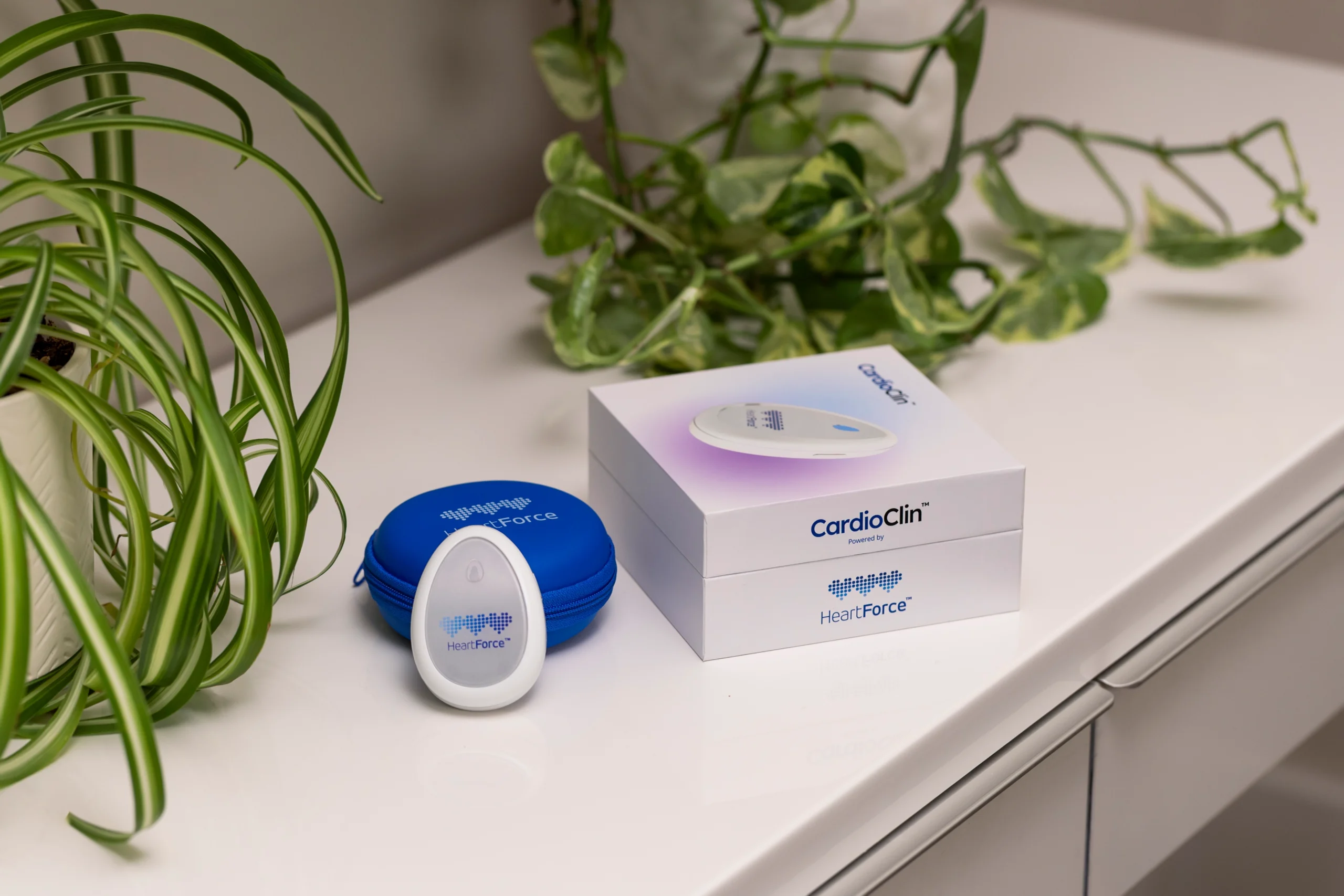 CardioClin sensor with the blue HeartForce pouch and product box